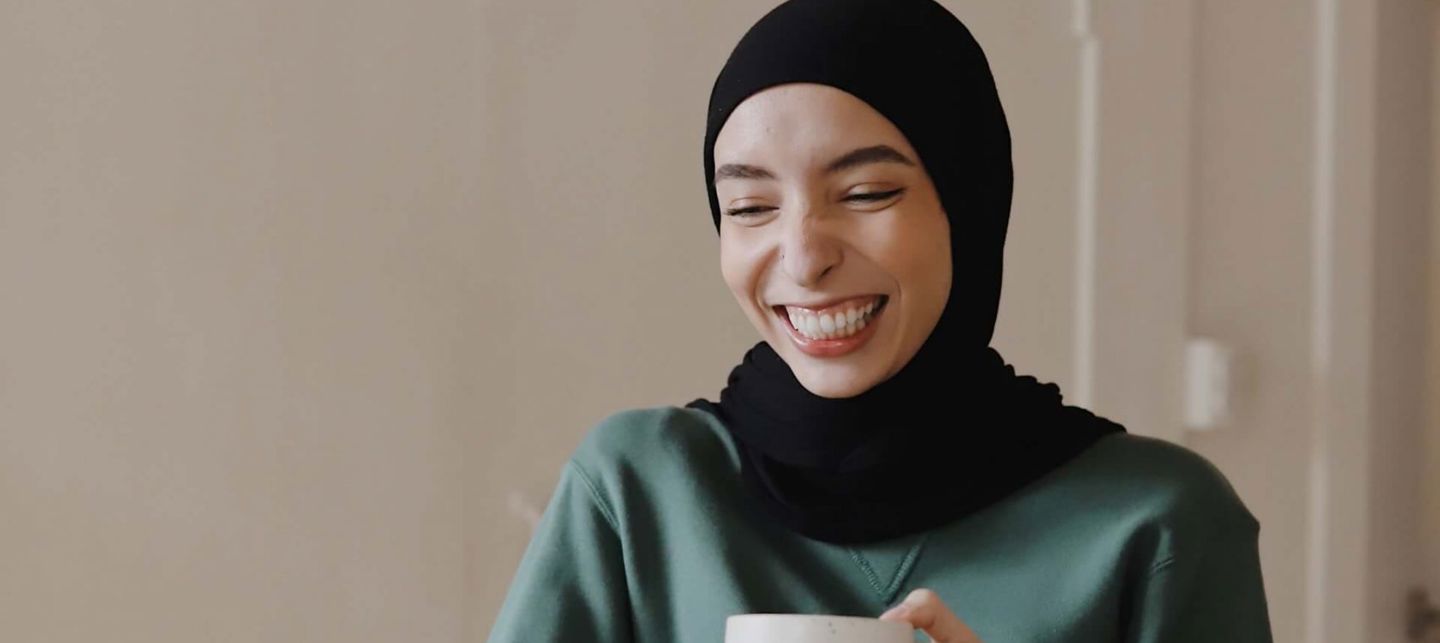 woman drinking coffee on laptop