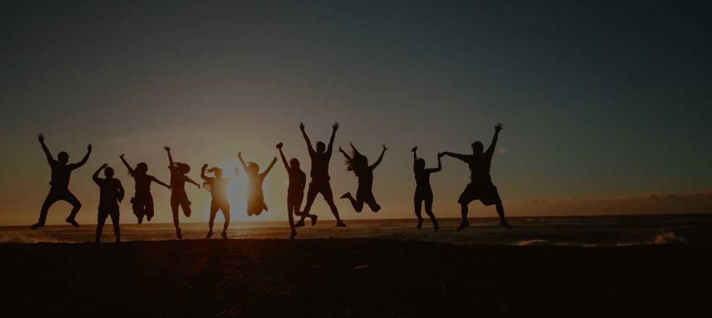 silhouette of people jumping at sunset