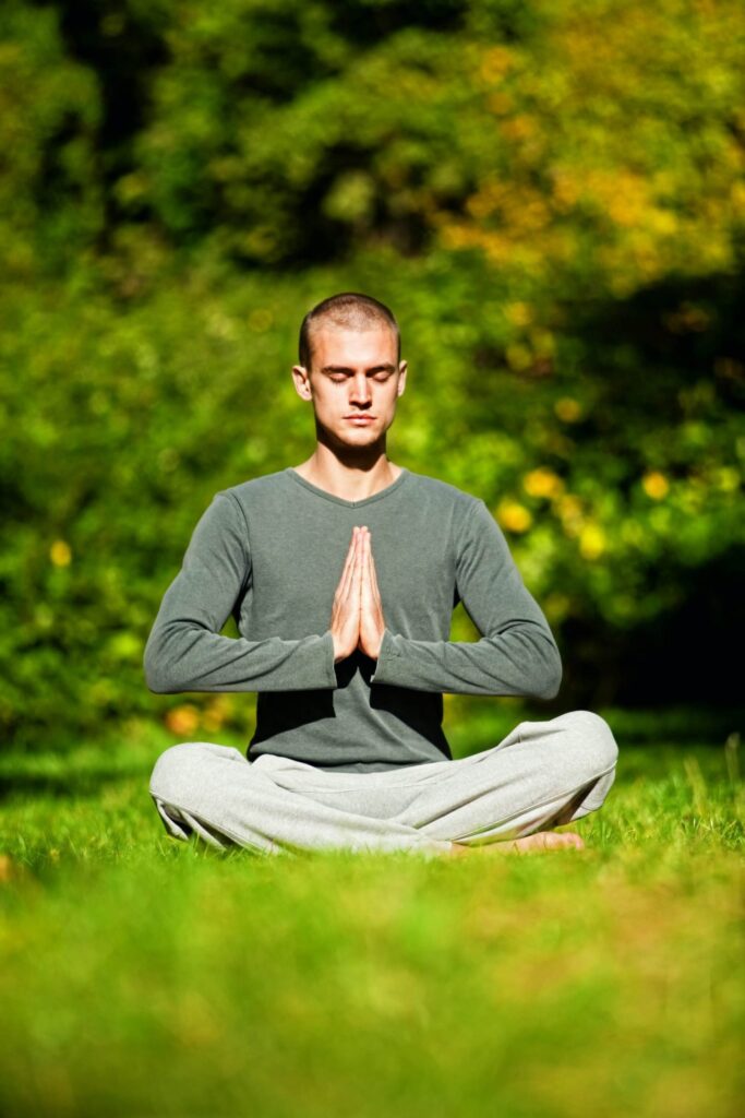 man meditating in garden