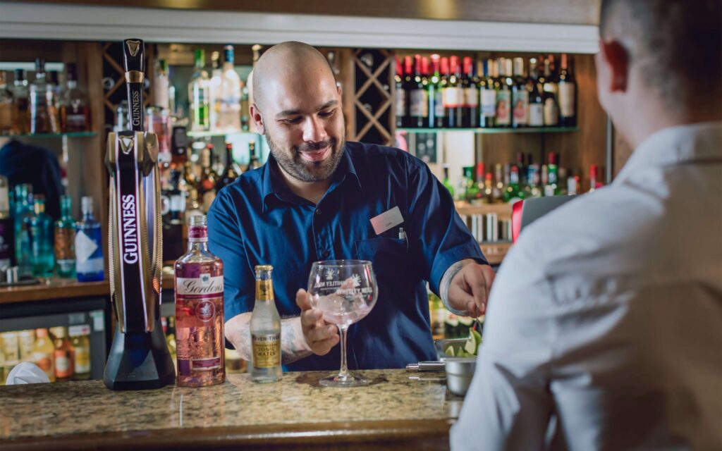 barman serving cocktails at yarnfield park bar