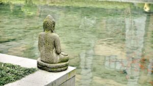 Buddha statue by pond meditation retreat