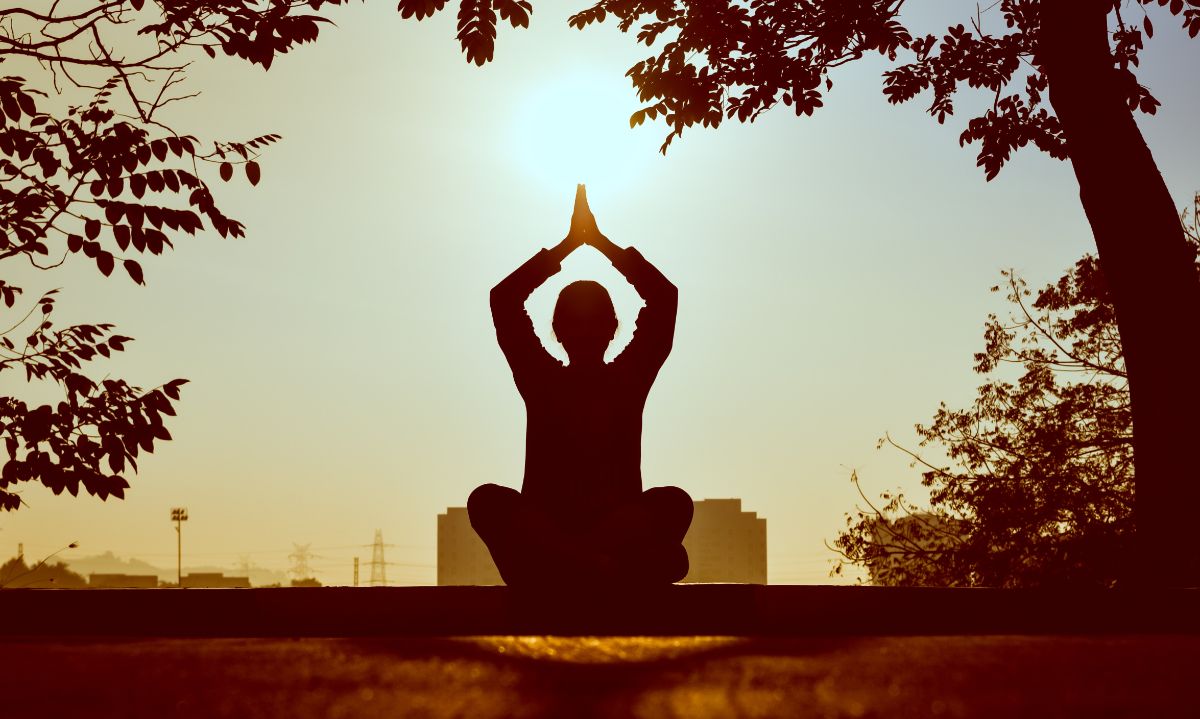 silhouette of a man meditating