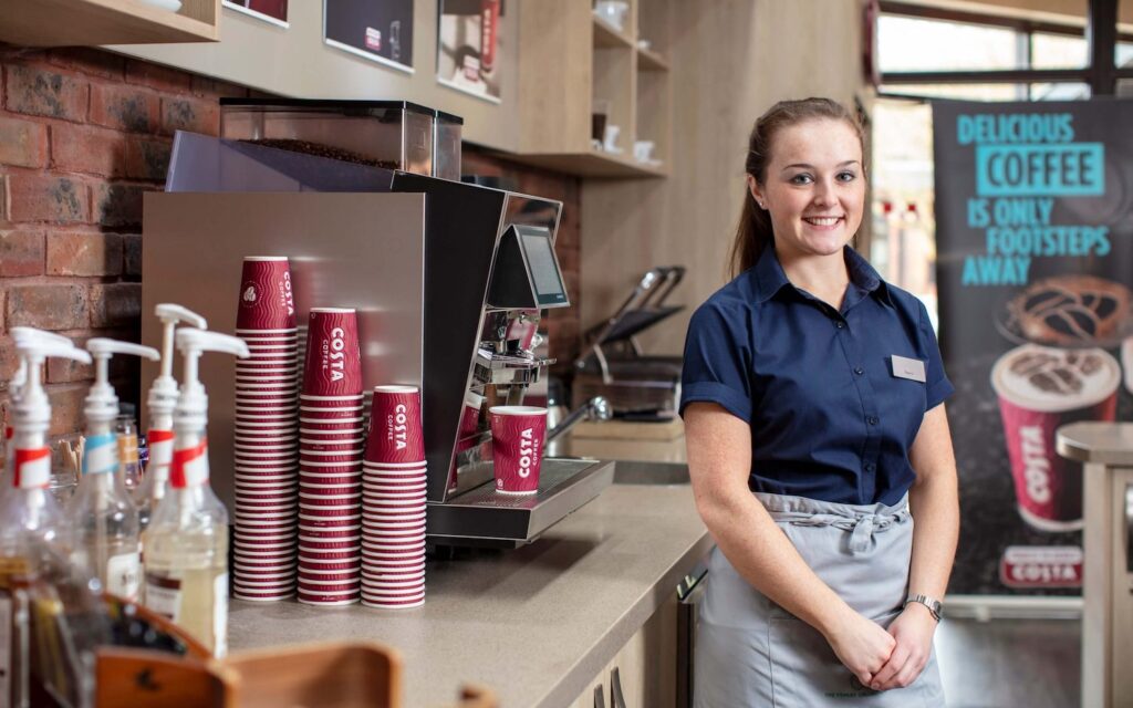 staff member at costa coffee station