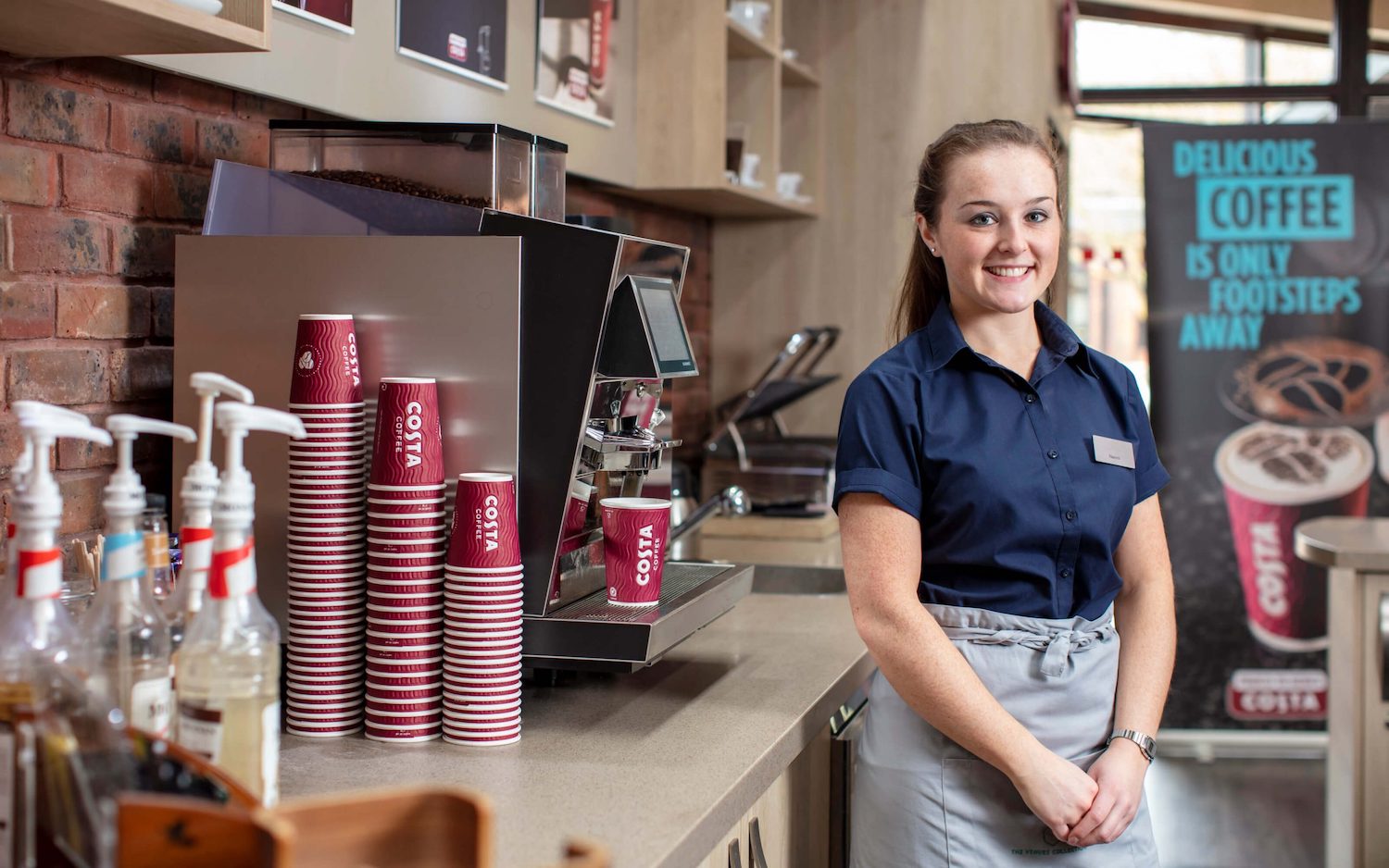 staff member at costa coffee station